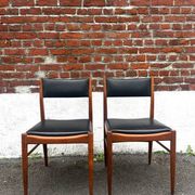 Set of 2 vintage Scandinavian chairs in wood and black faux leather.