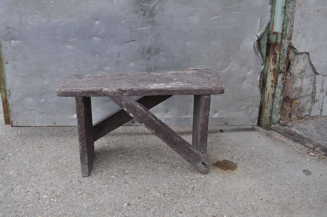 Low stool in vintage brown painted pine from the 1940s, with a rectangular seat.