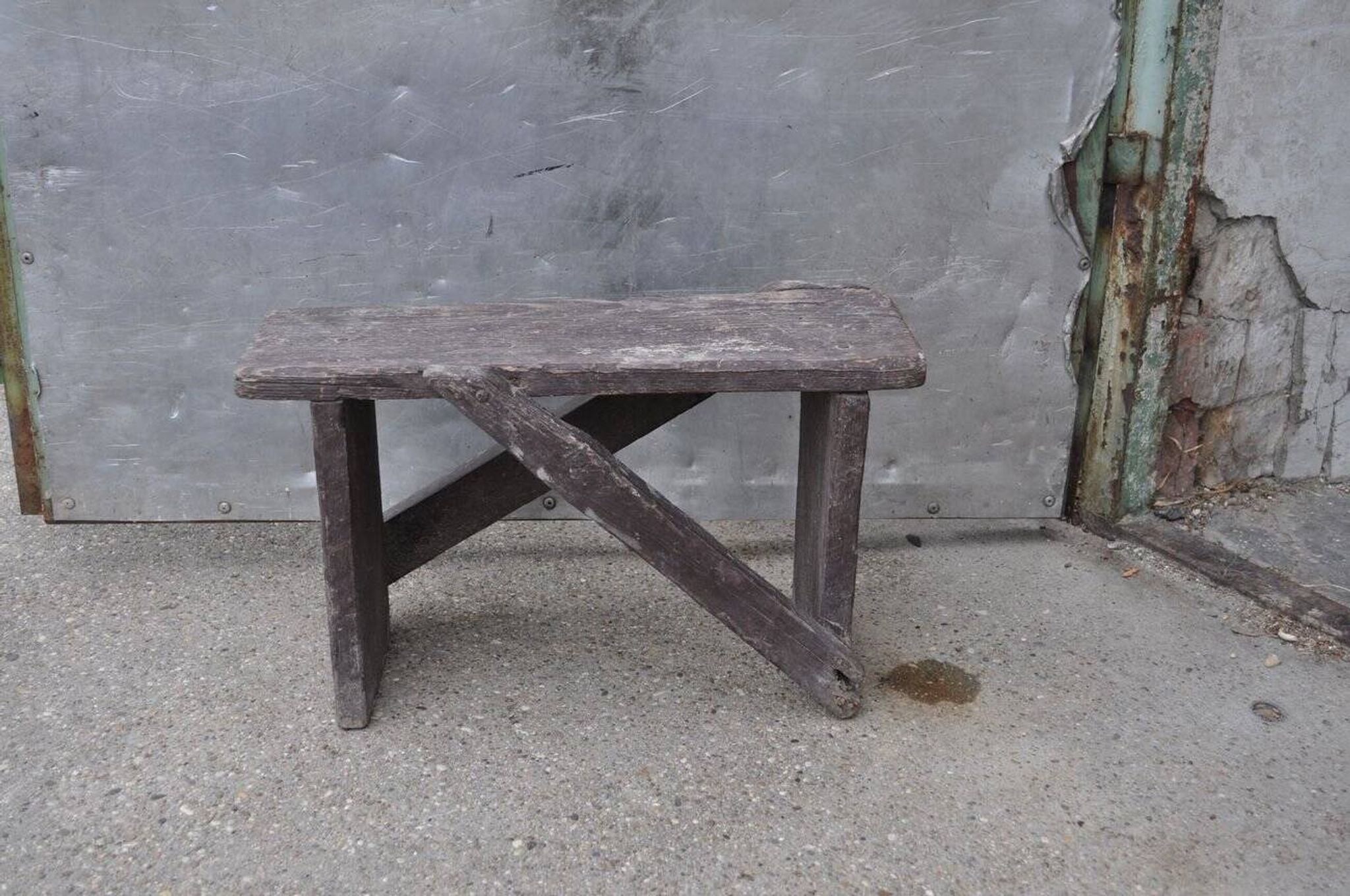 Low stool in vintage brown painted pine from the 1940s, with a rectangular seat.