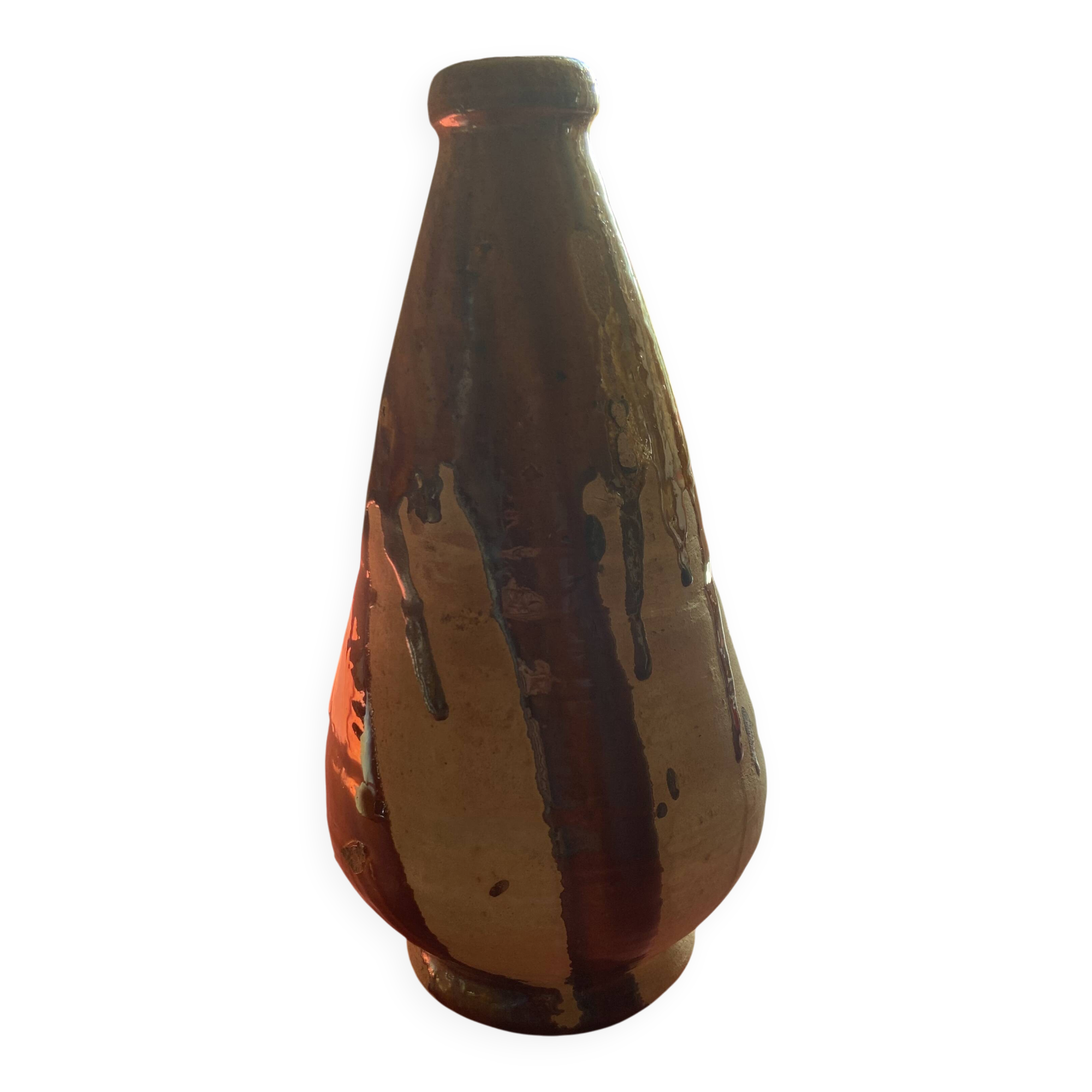 Large antique pottery bottle in glazed terracotta with drips.