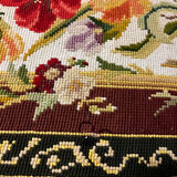 Vintage upholstered footstool, floral decor in Aubusson style.