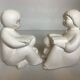 Pair of bookends with a matte white glaze for children.