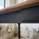 Oak farmhouse table with turned black legs.