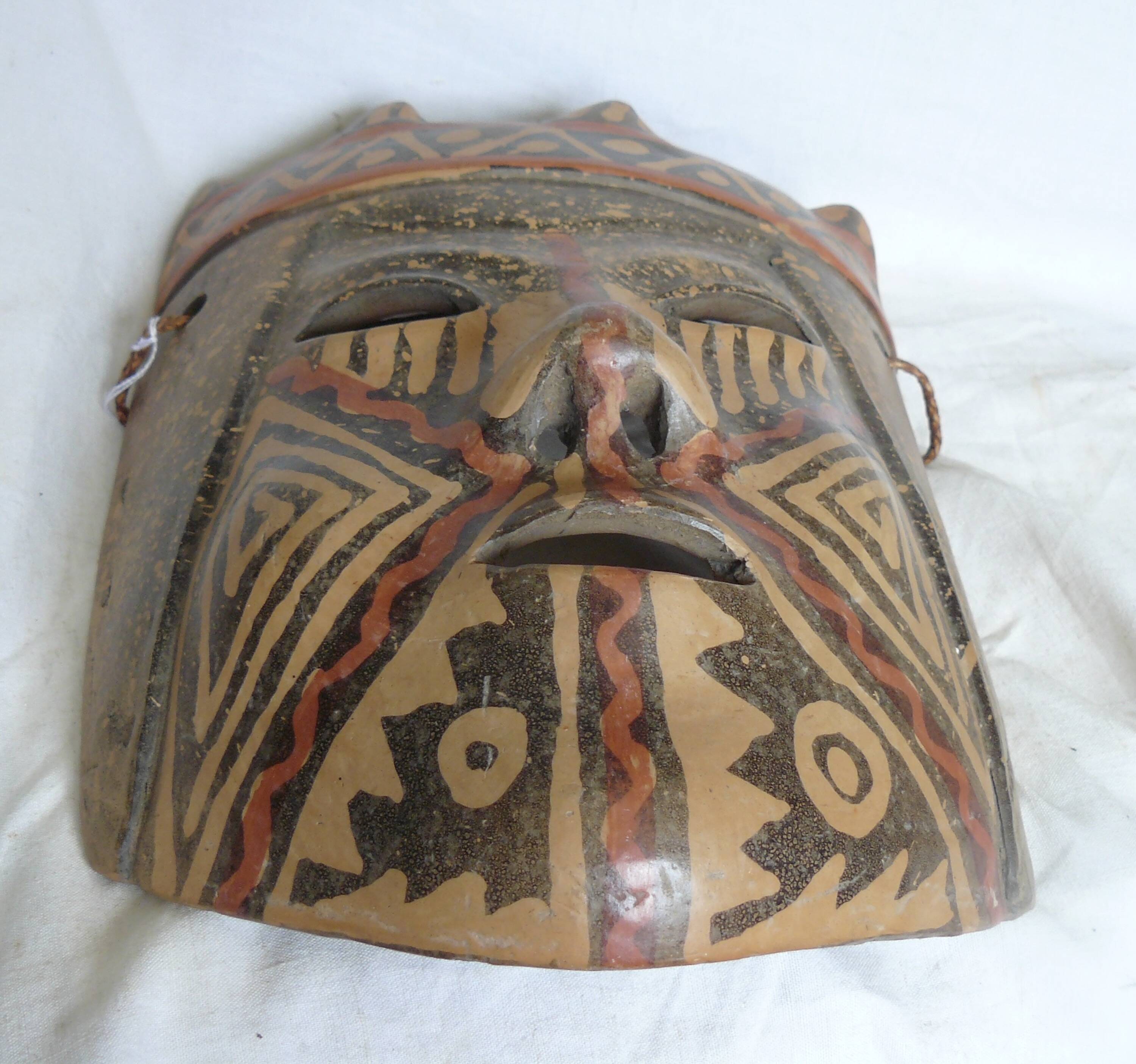 Terracotta mask with geometric decorations