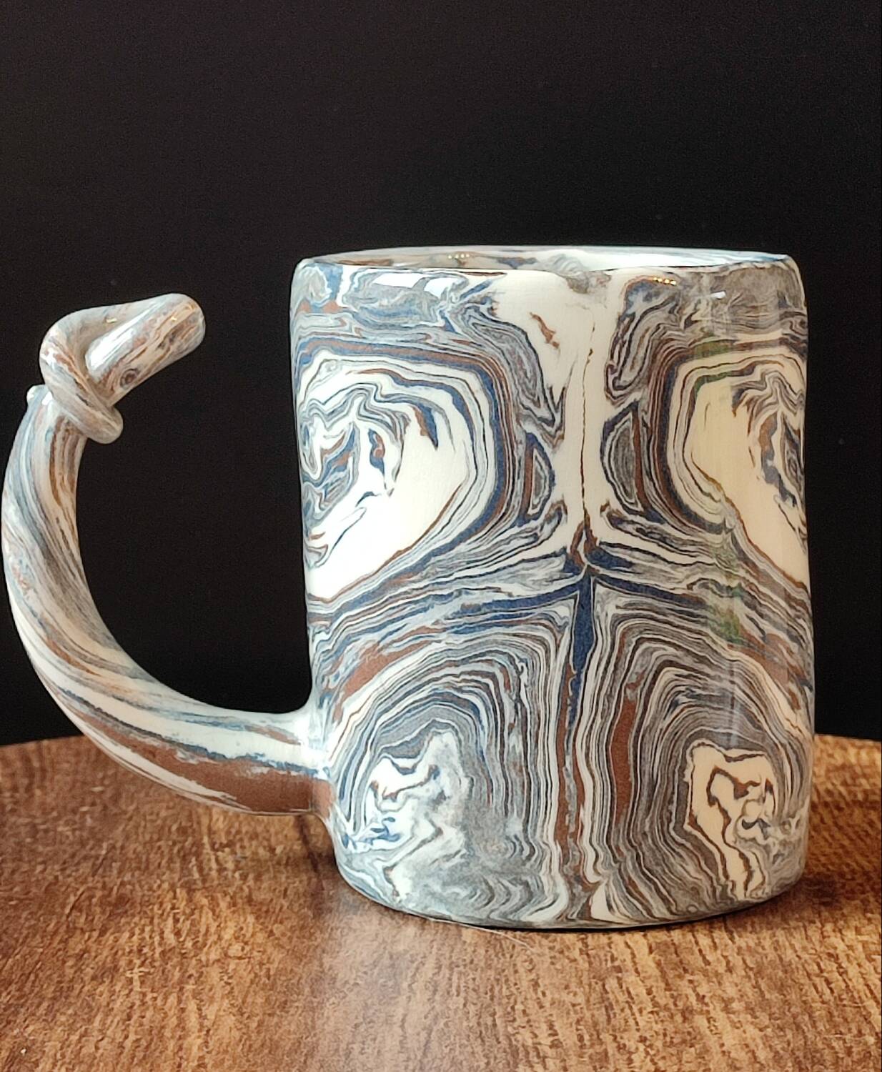 Handcrafted ceramic mug with marbled design, unique piece.