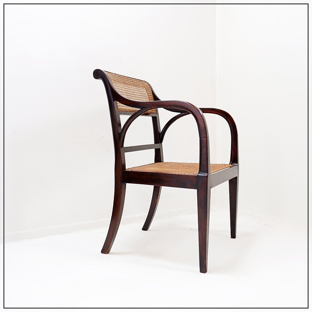 Mid-century curved wooden chairs with cane seats and backs.