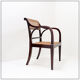 Mid-century curved wooden chairs with cane seats and backs.