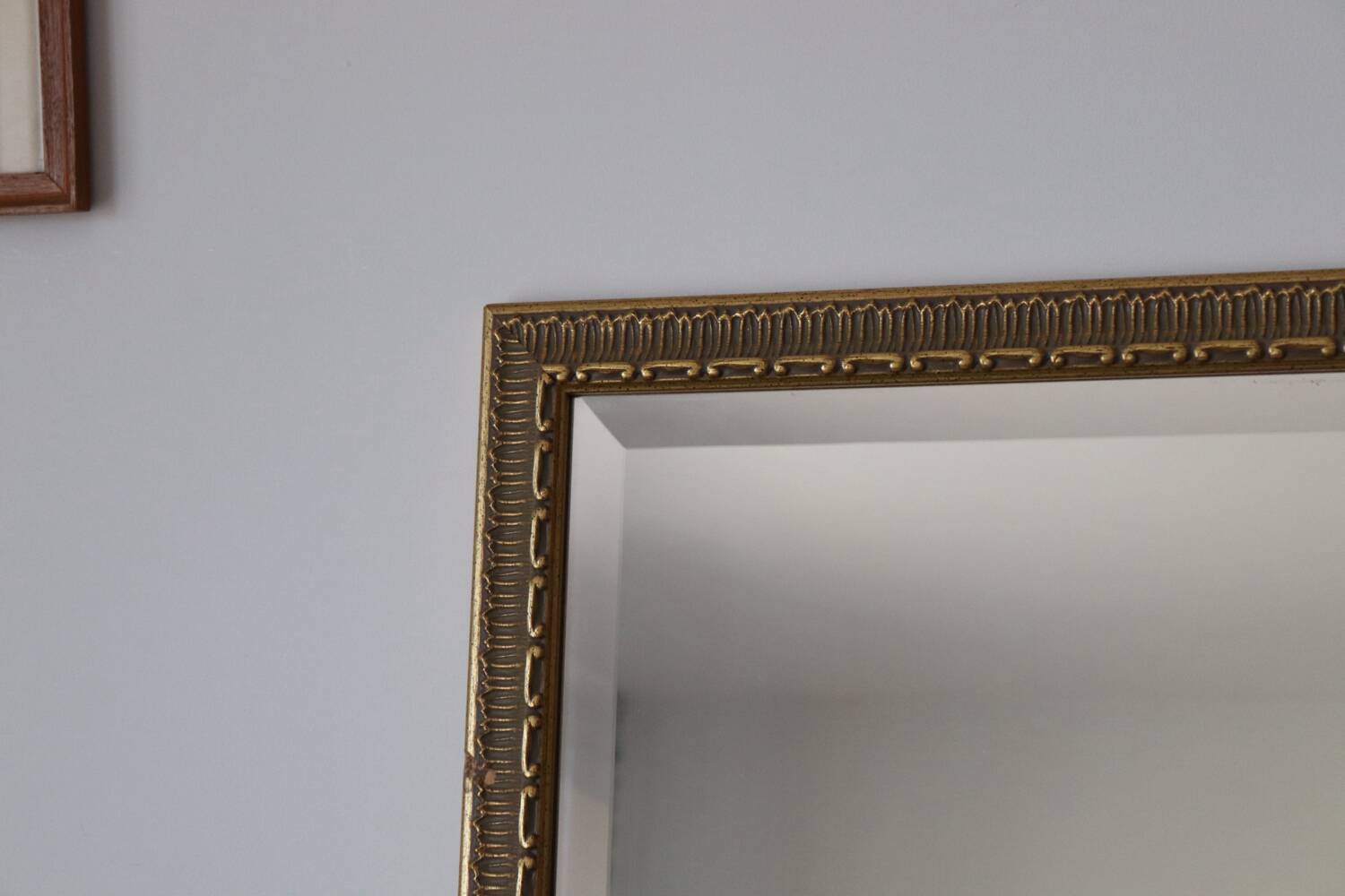Rectangular gold mirror with moulded decoration.