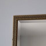 Rectangular gold mirror with moulded decoration.