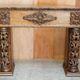 Antique fireplace from around 1880 in solid hand-carved elm with openwork columns.