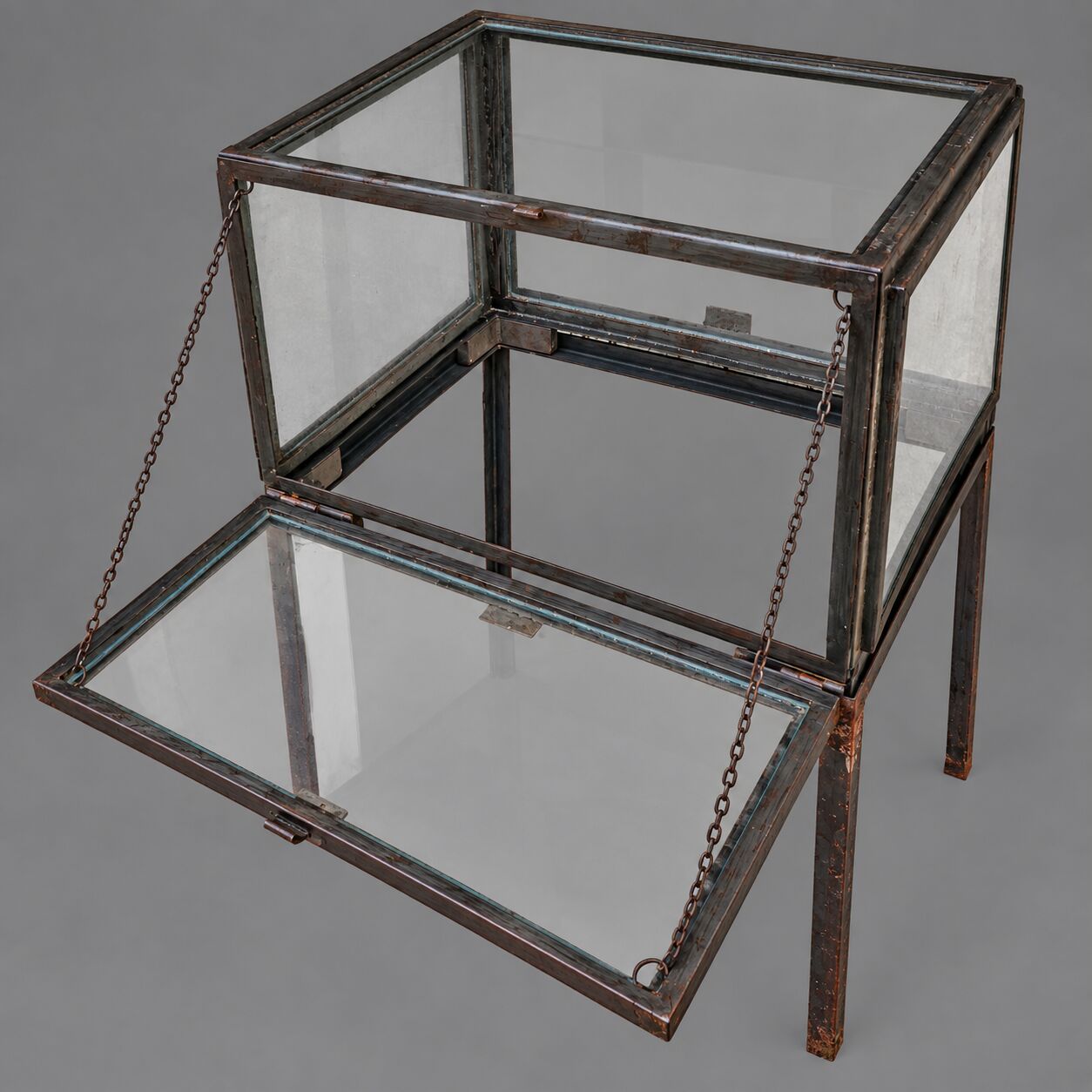 A showcase made of steel and glass, mounted on a custom-made steel base.