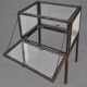 A showcase made of steel and glass, mounted on a custom-made steel base.