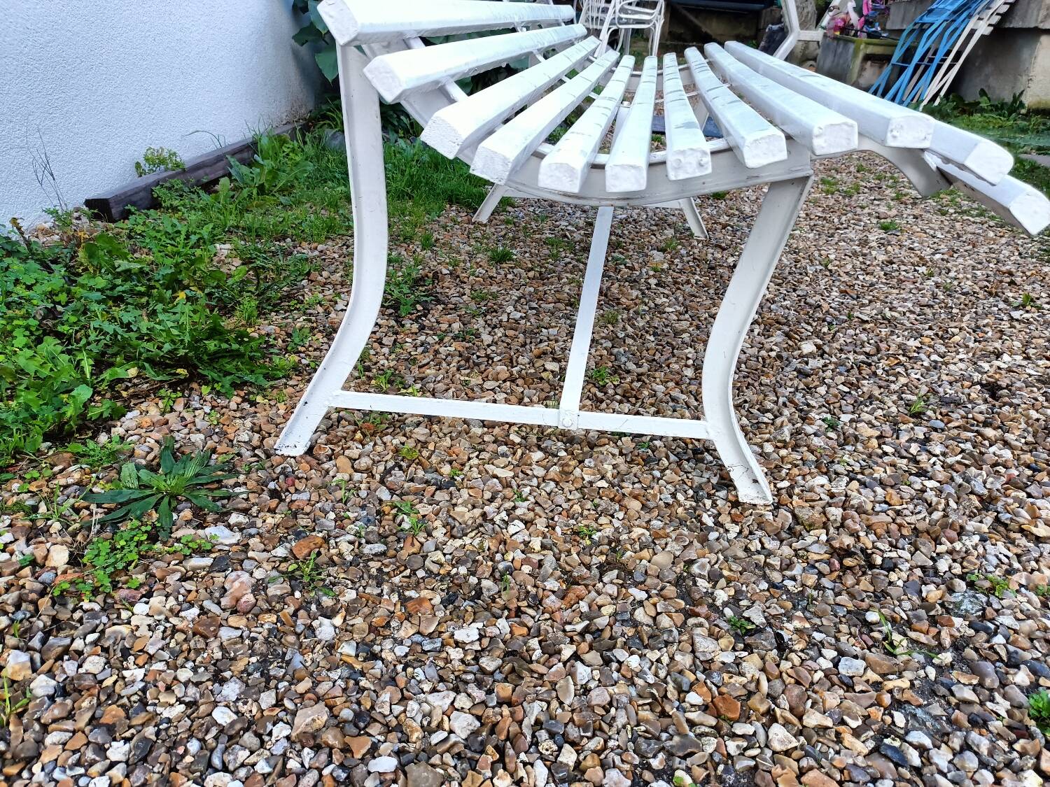 Old garden bench with metal legs and wooden slats