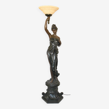 Floor lamp depicting a woman draped in antique style, her right arm raised holding a torch