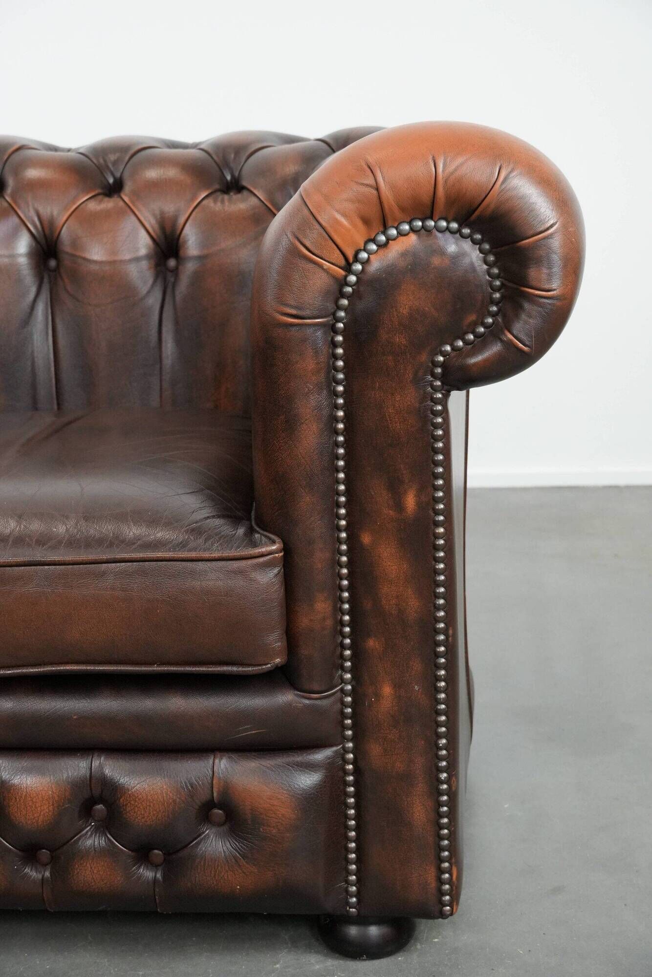 Brown Chesterfield armchair made of cowhide leather in English style