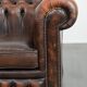 Brown Chesterfield armchair made of cowhide leather in English style
