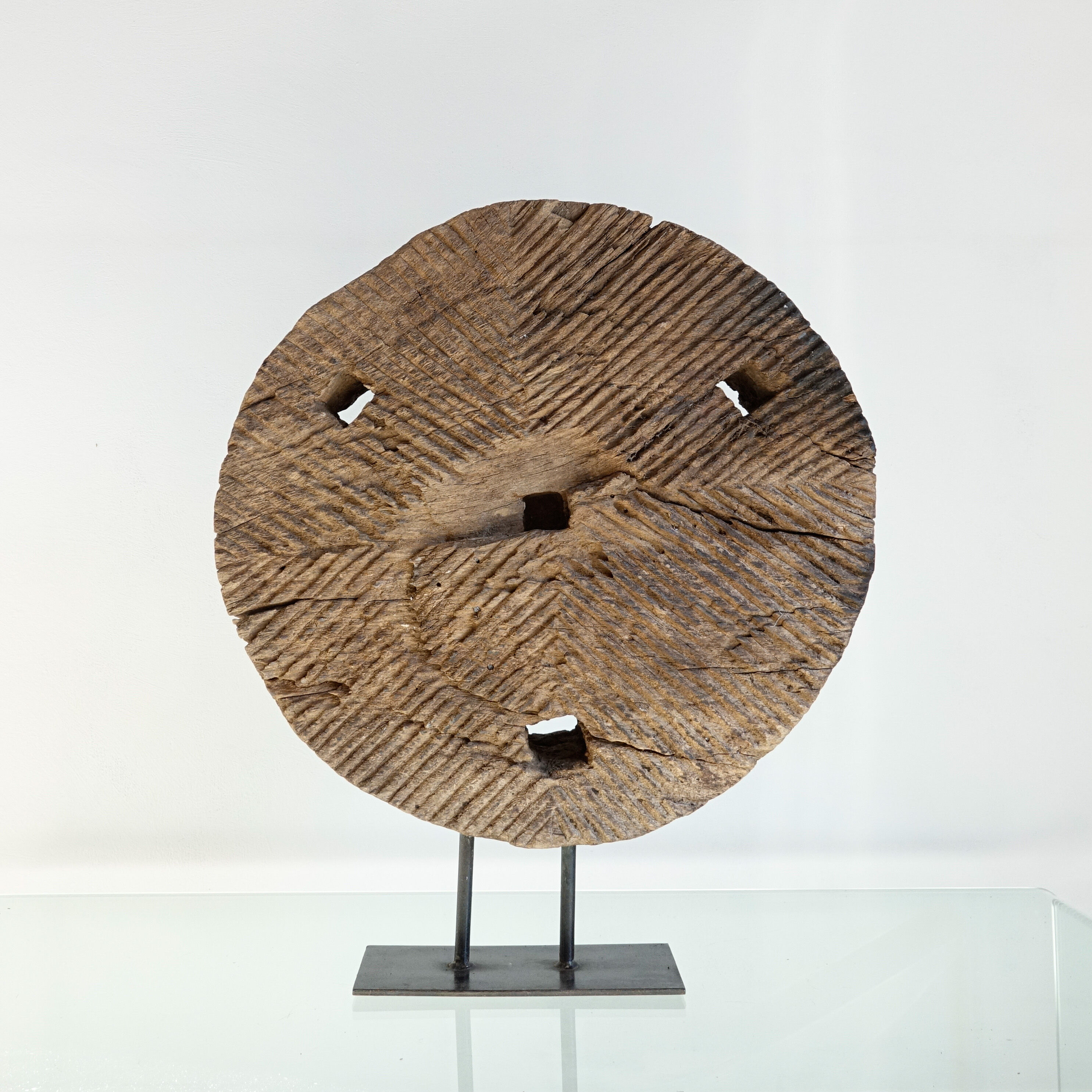 Old decorative wooden wheel on foot