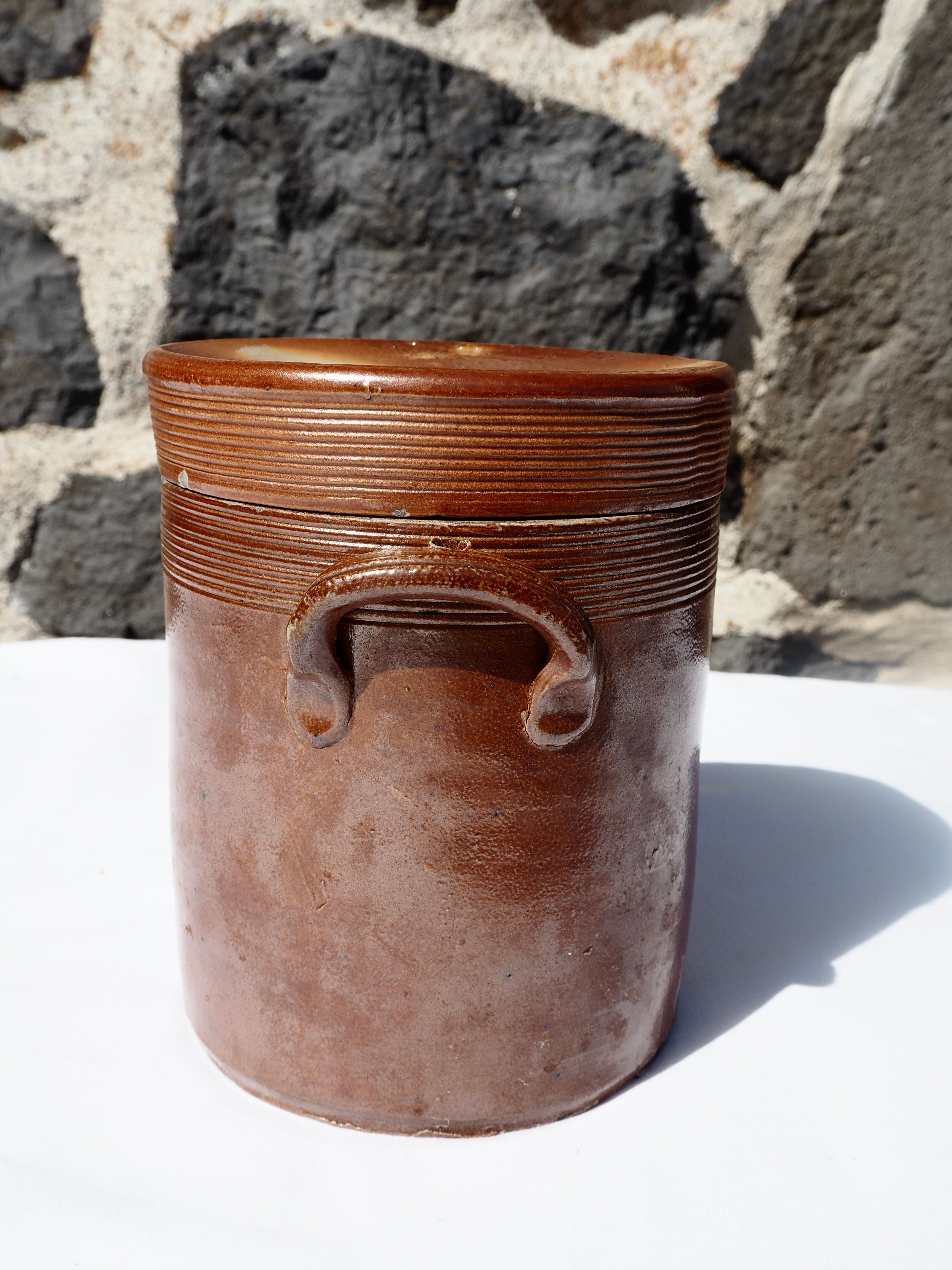 Trio of stoneware pots with lids