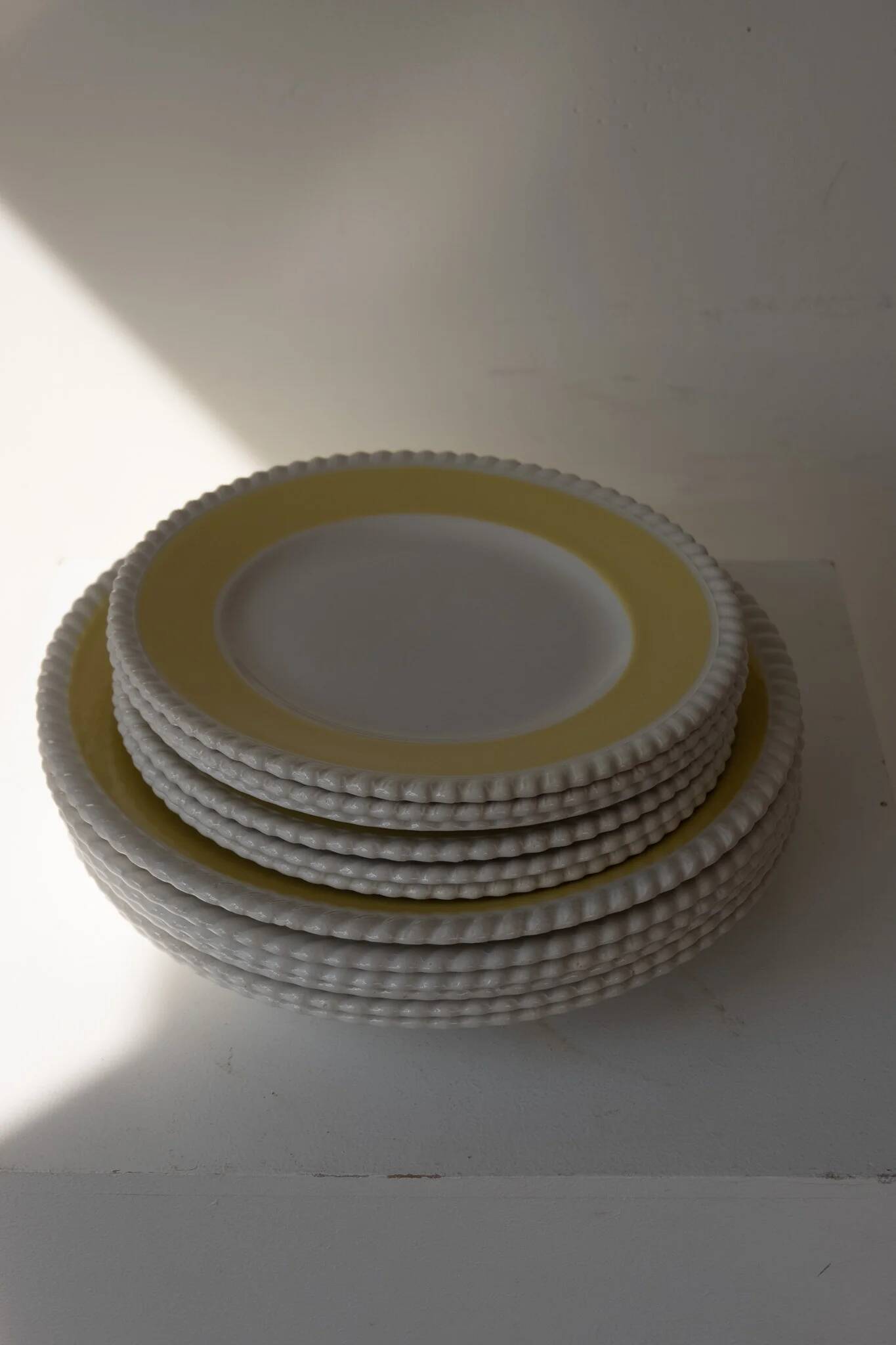 Vintage yellow butter ceramic dinnerware set with swirl border.
