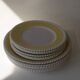 Vintage yellow butter ceramic dinnerware set with swirl border.