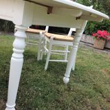 White farmhouse table set and four chairs