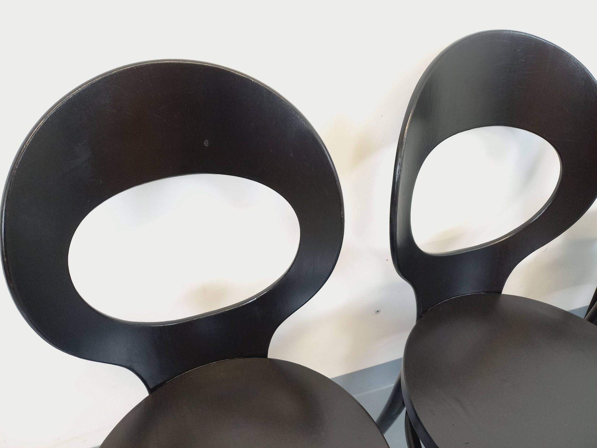 Set of 4 vintage Mouette chairs by Baumann in black wood from the 1960s.