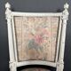 Antique Louis XVI style chair with patinated wood and floral fabric.