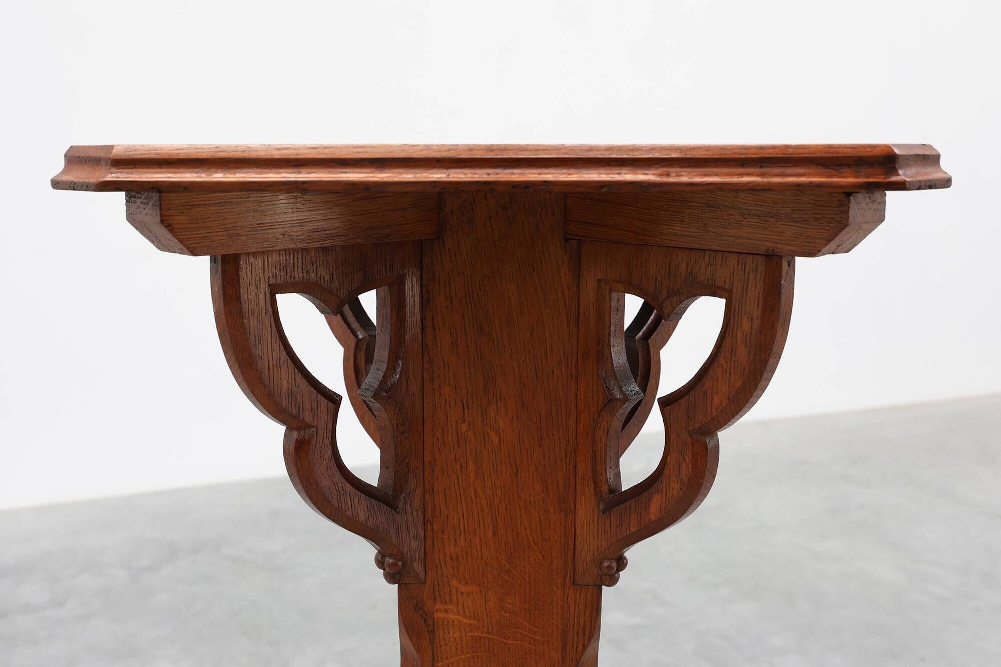 Art Deco oak pedestal with pierced brackets and cross base, Belgium 1920s