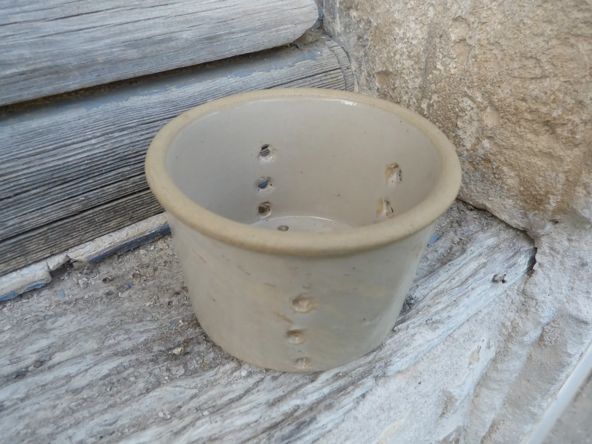 Beige stoneware cheese drainer