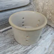 Beige stoneware cheese drainer
