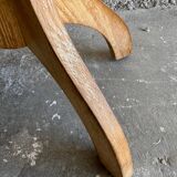 Vintage natural wood stool with light yellow faux leather seat and crossed splayed base