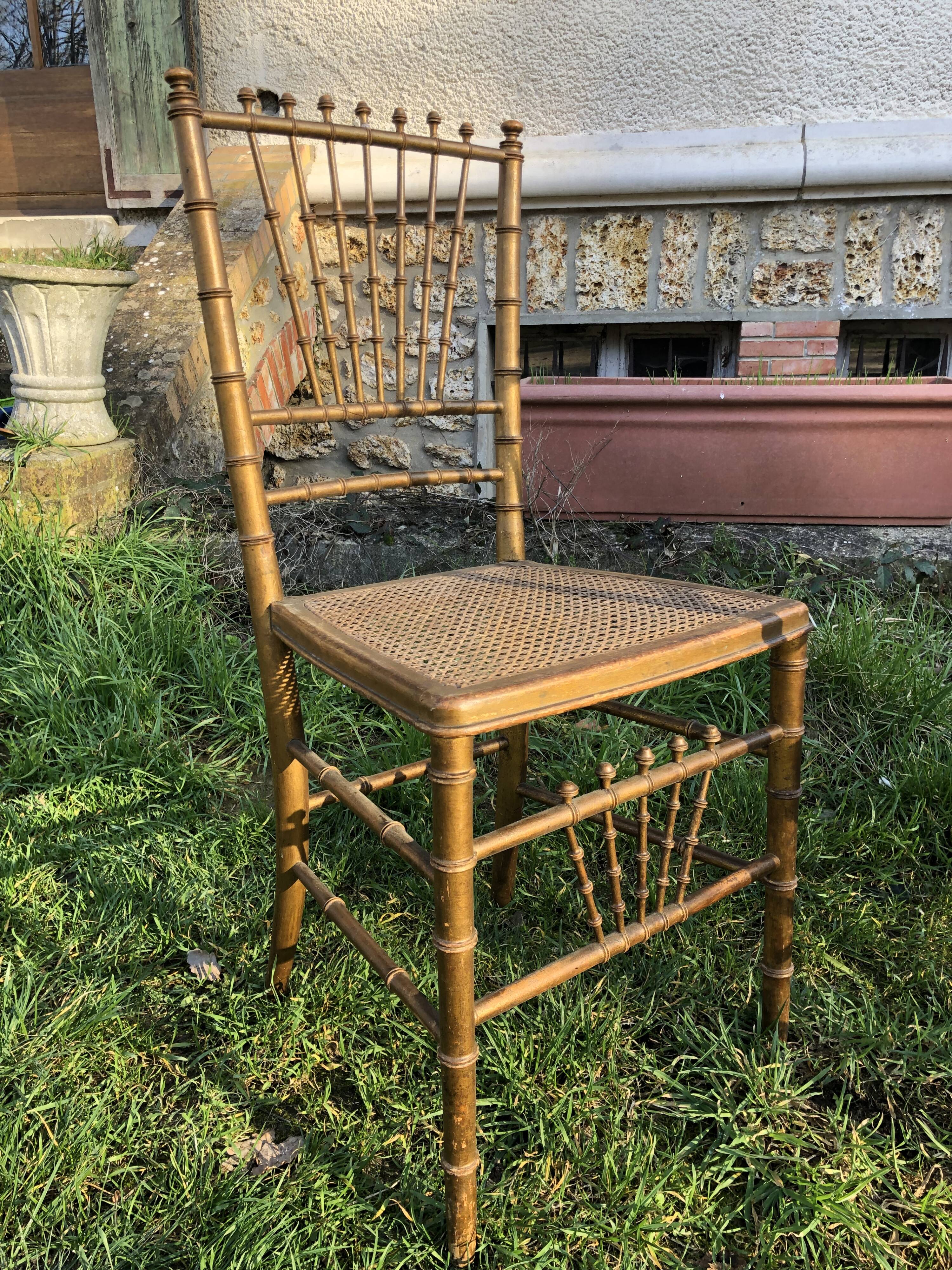 Pair of caned chairs in gilded wood
