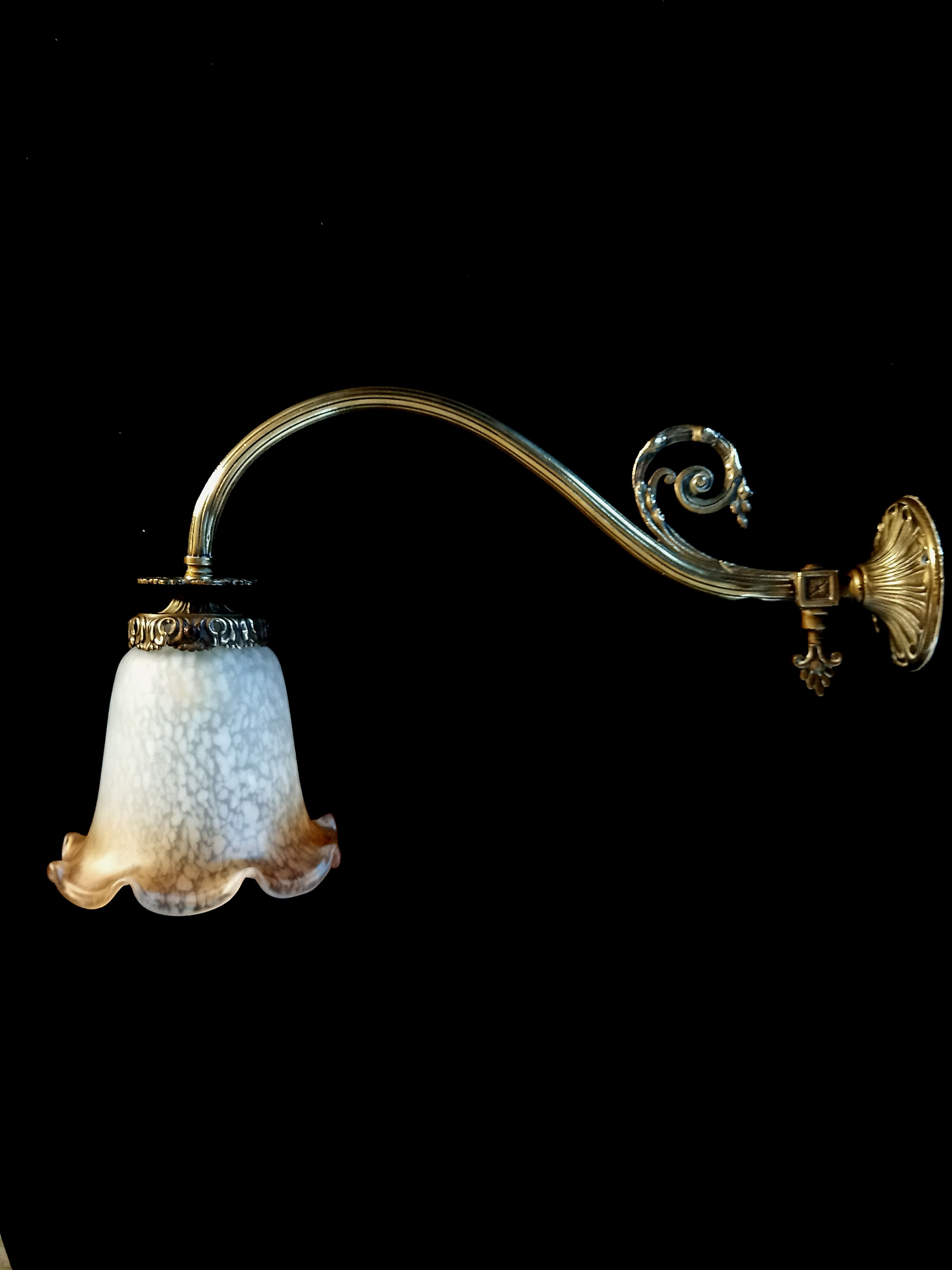 Brass wall lamp with speckled glass tulip