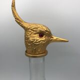 Glass bottle type carafe with gold metal bird head stopper