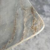 Light gray solid granite coffee table with organic triangular shape and conical base, 1980s