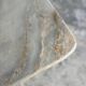 Light gray solid granite coffee table with organic triangular shape and conical base, 1980s