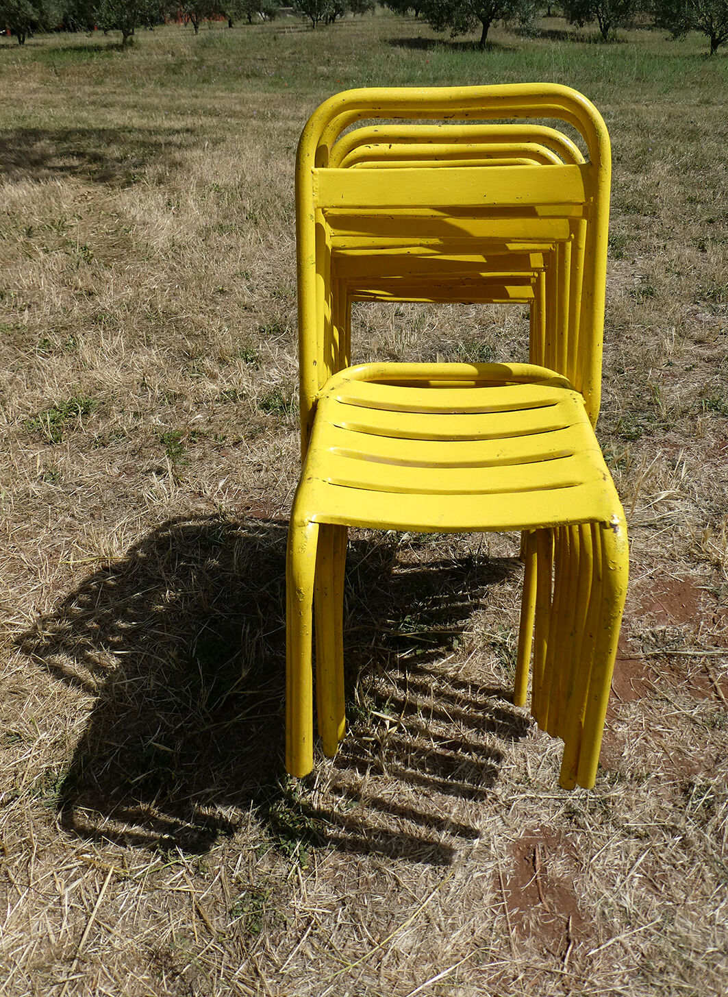 Lot of 11 yellow metallic bistro chairs from the 1950s