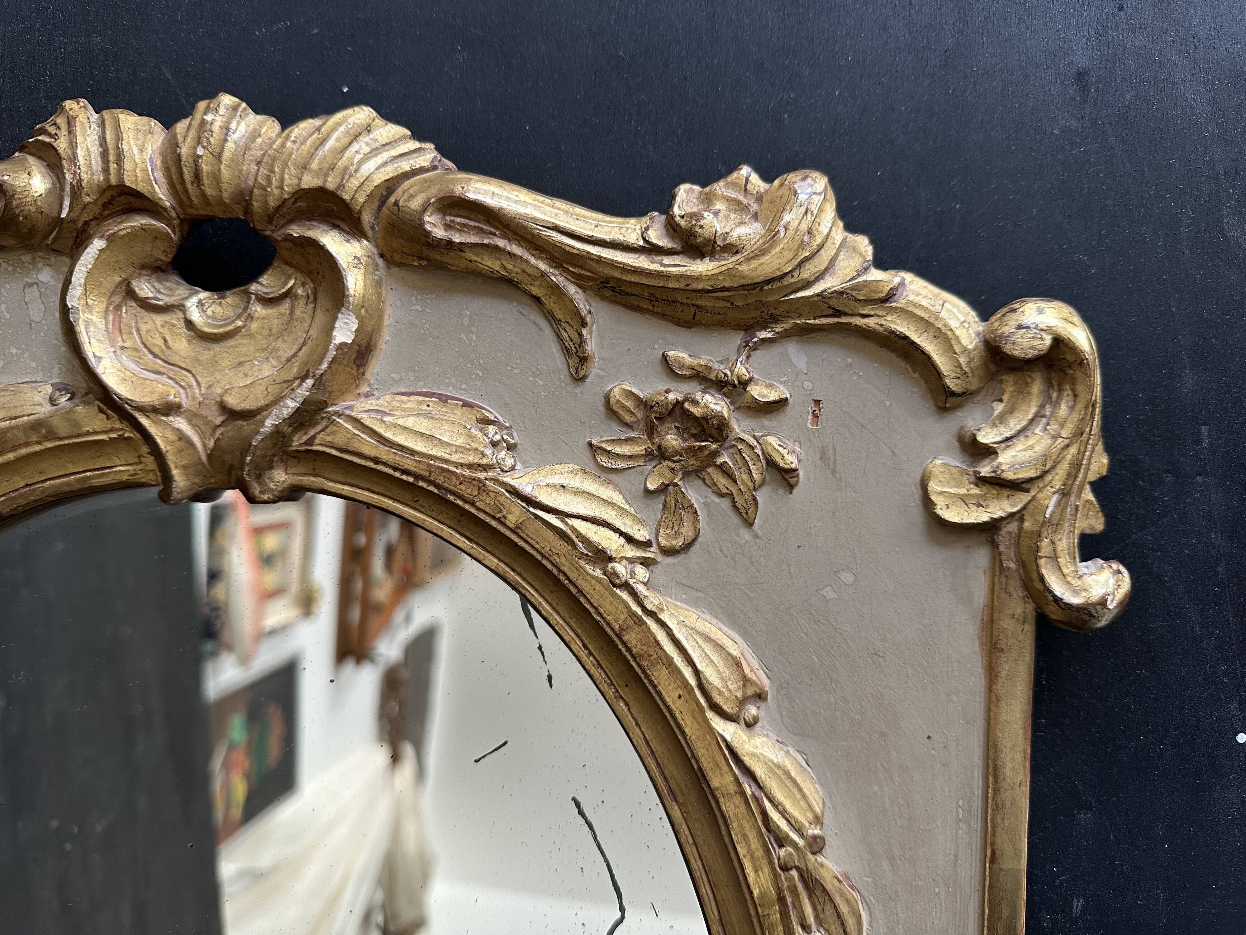 Napoleon III mirror in carved gilded wood, oval mercury glass.