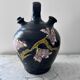 Black water jug with floral decoration