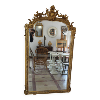 Large 19th-century wooden and gilt-studded mirror decorated with a cornucopia motif.