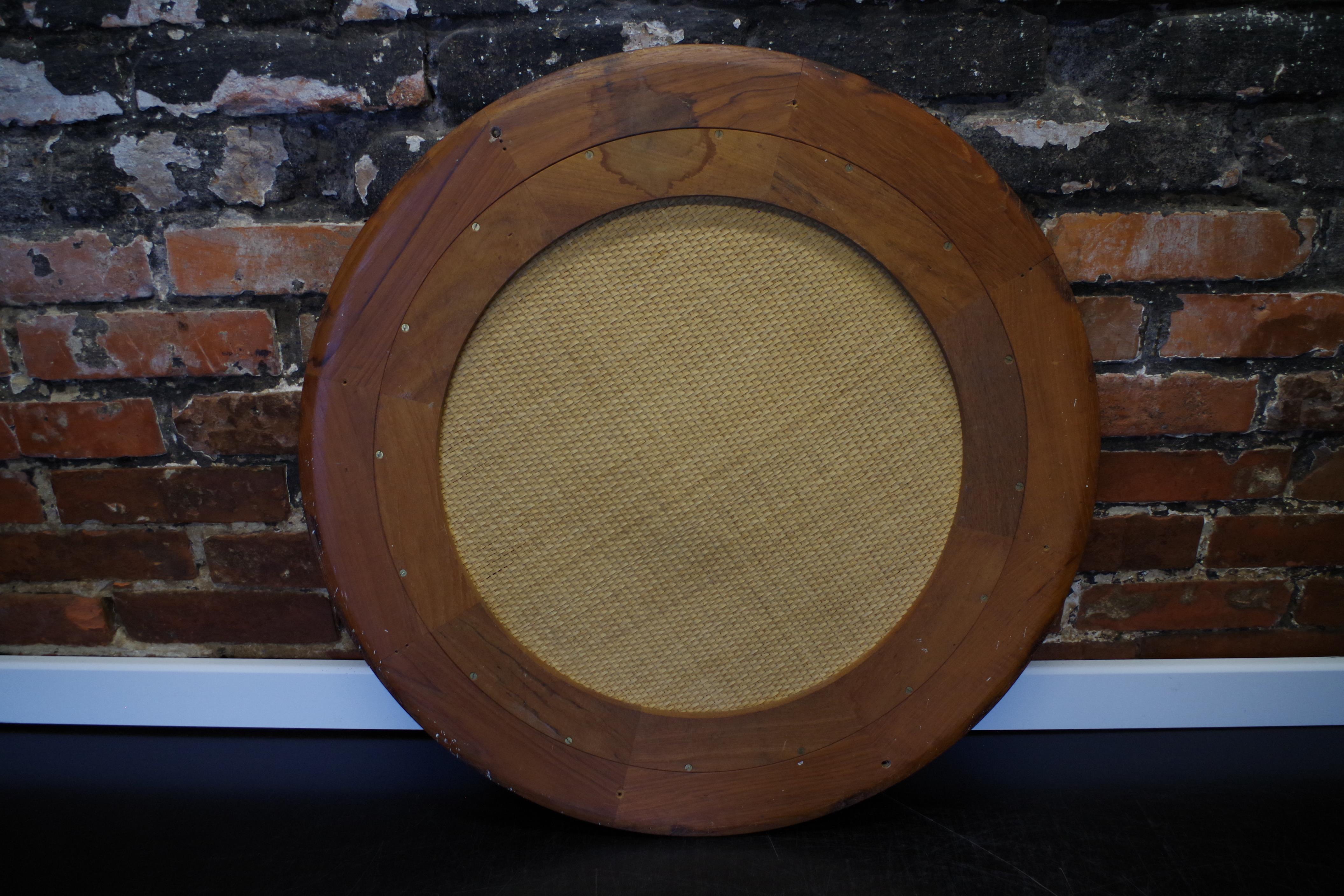 Round mirror in a vintage teak wood frame