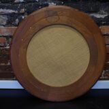 Round mirror in a vintage teak wood frame