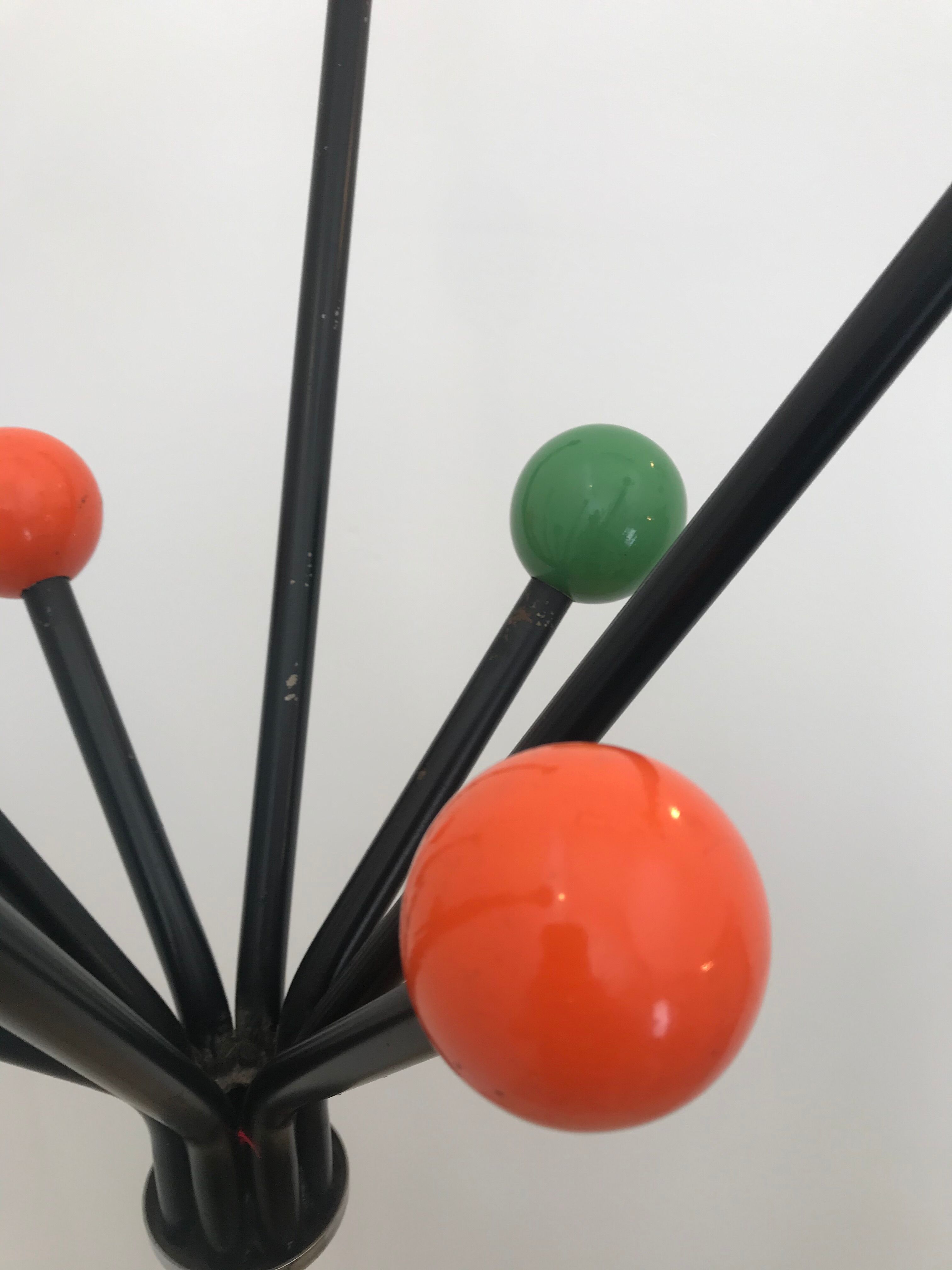 Wearing chrome parrot coat, black and multicolored balls