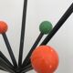 Wearing chrome parrot coat, black and multicolored balls