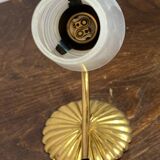 Gold metal wall light with ribbed glass.