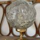 Textured round globe table lamp with a gold brass base