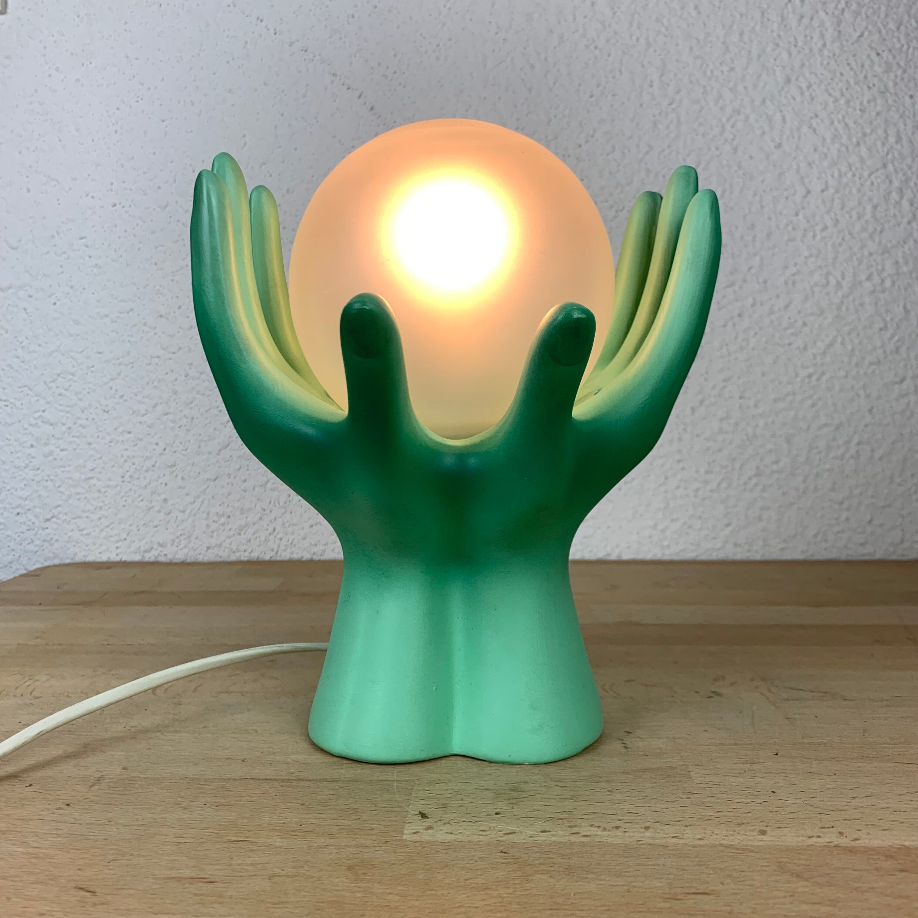 Green ceramic hand lamp and glass globe