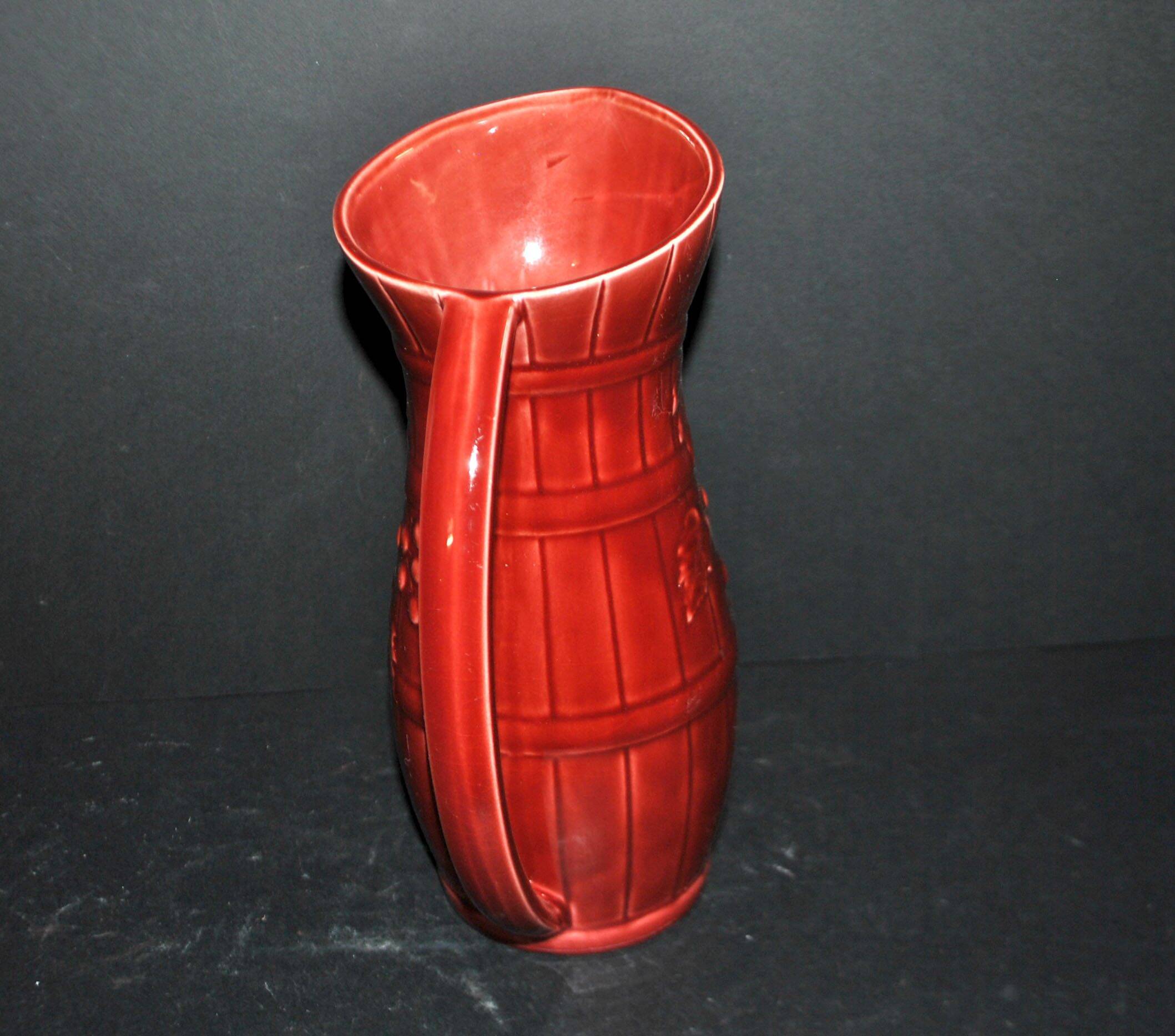 Sarreguemines wine jug in red slipware with grapevine decoration.