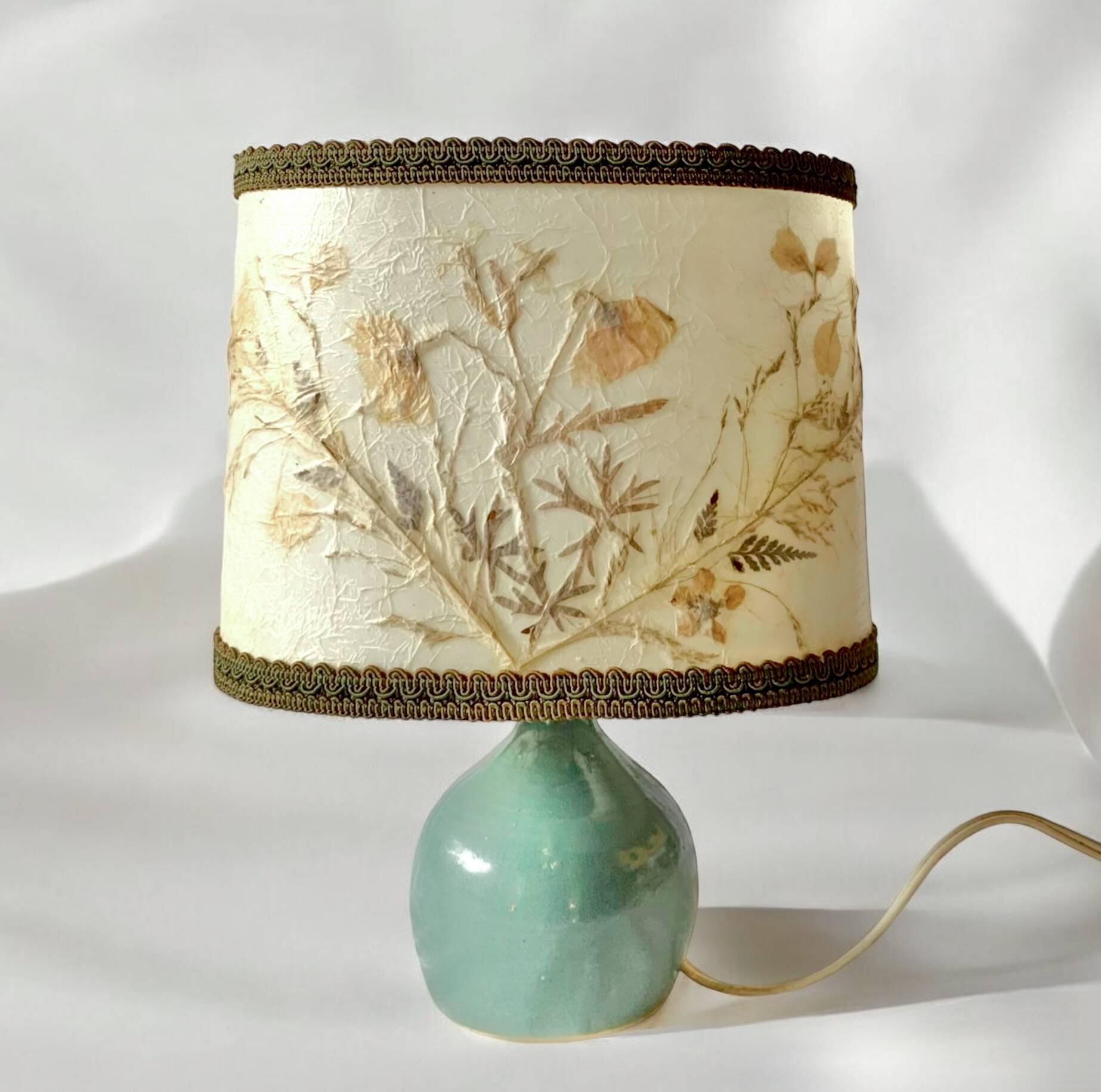 Old small green ceramic side lamp with dried flower lampshade