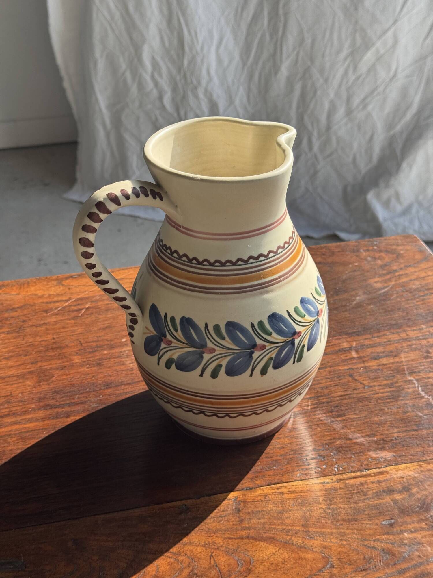 Beige carafe with stylized blue flower friezes